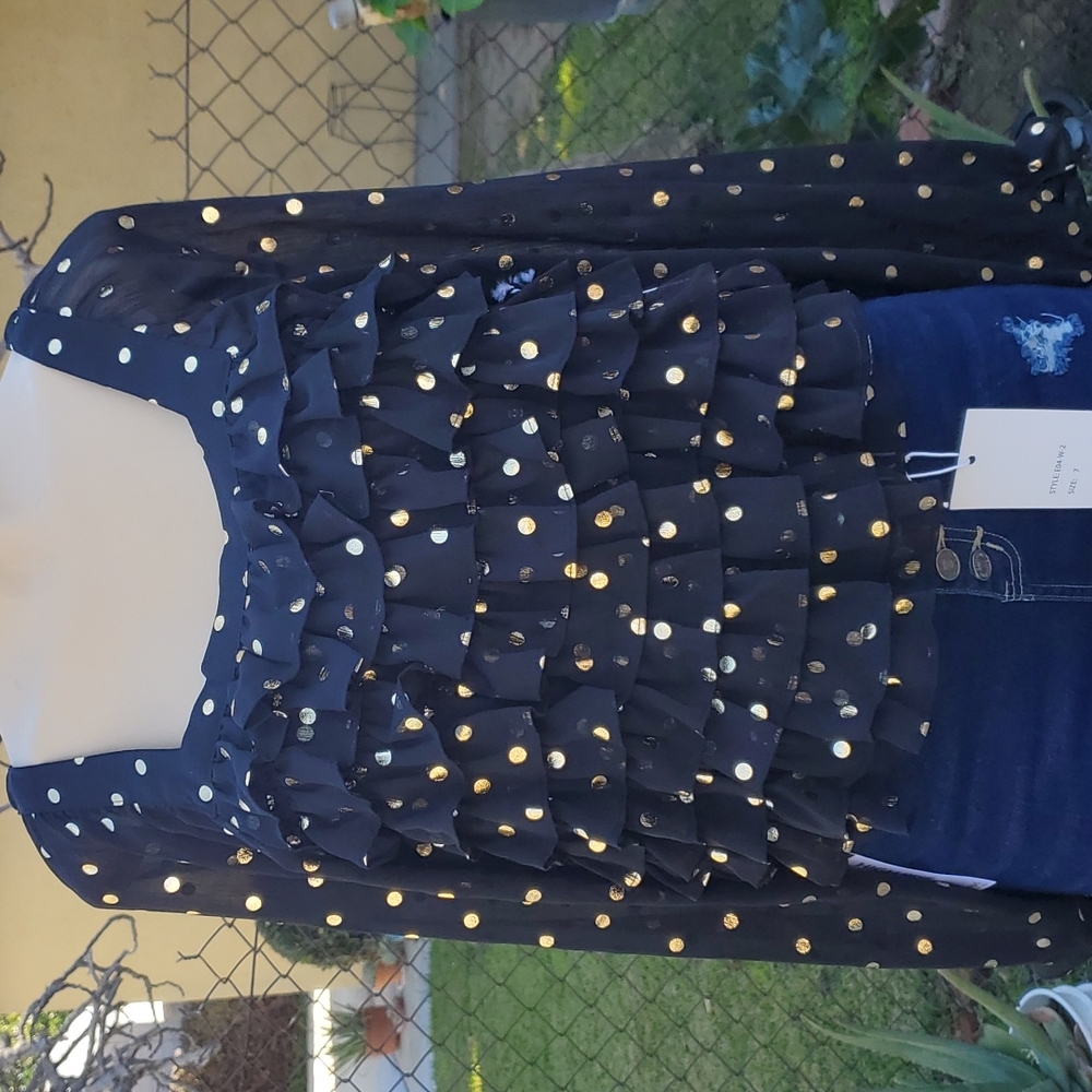 Black top with ruffles in the front. Material is very light not to thick.